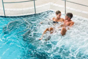 Couple In Thermal Wellness Spa On Water Massage